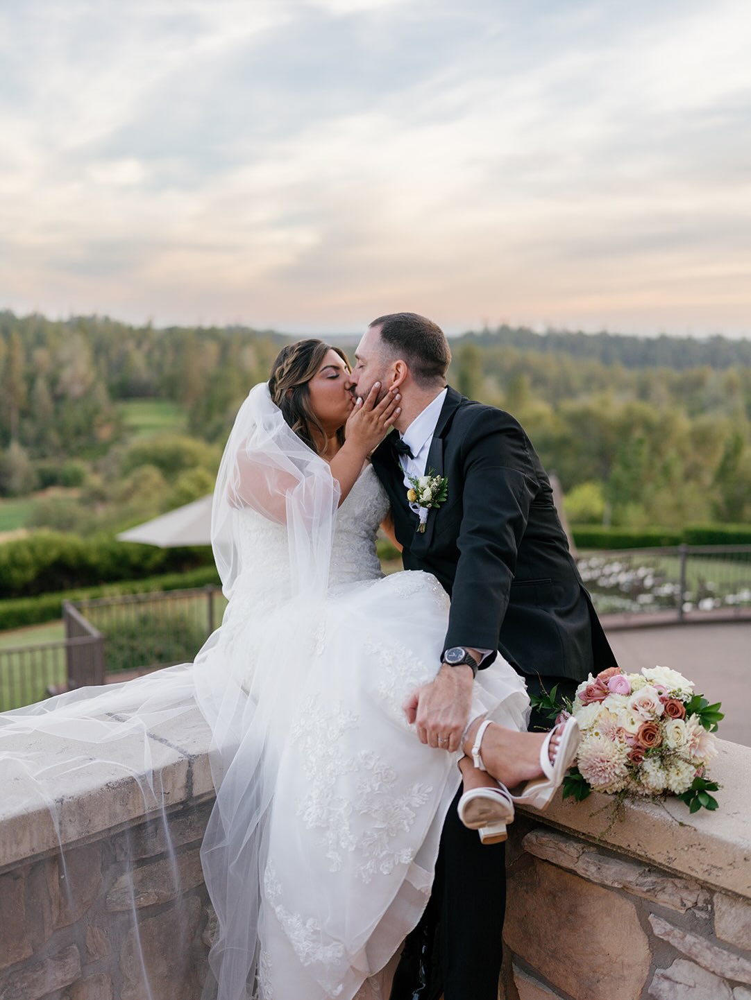 Bride and groom sharing a kiss outdoors