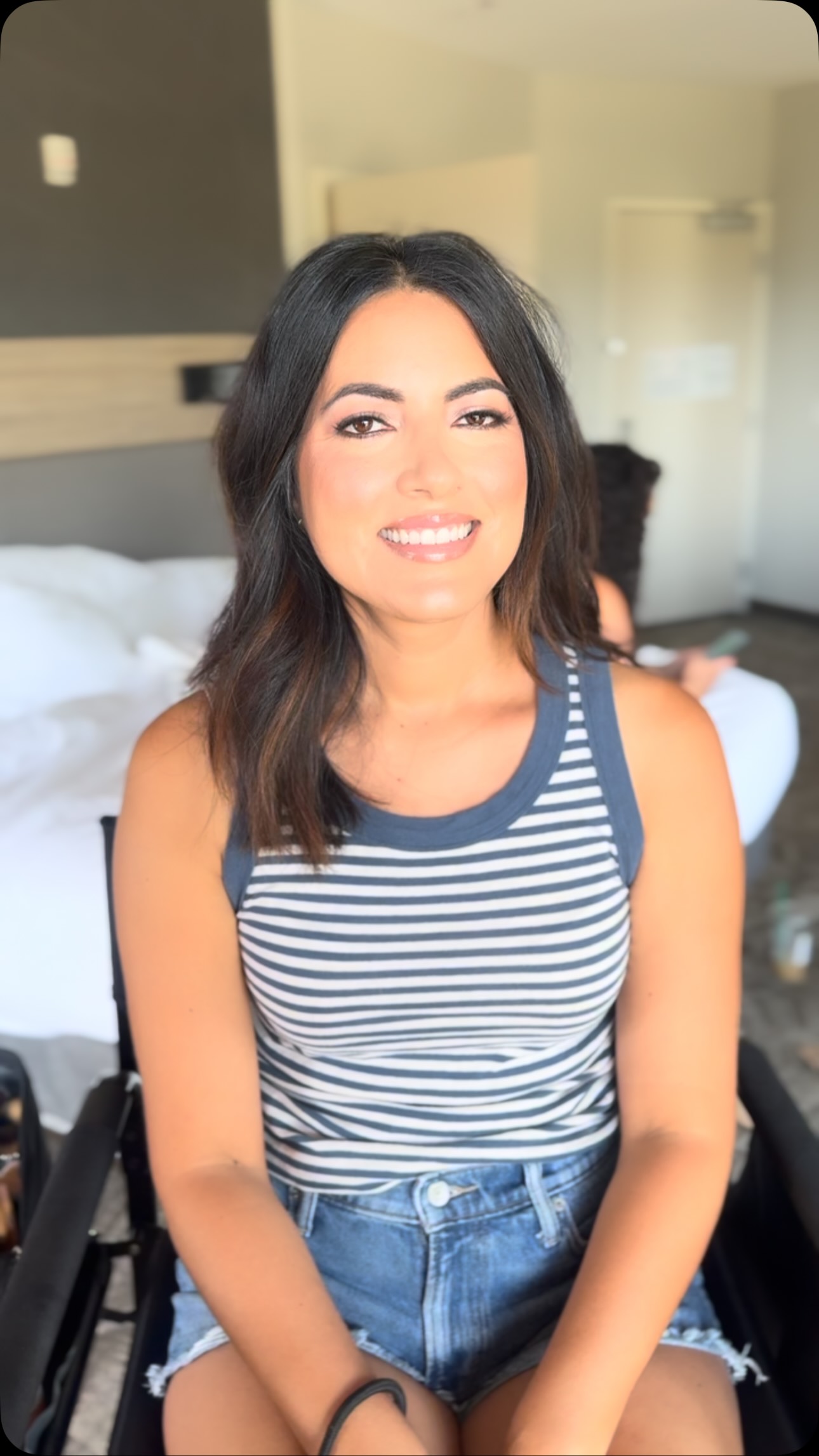 Dark-haired wedding guest wearing clean natural makeup