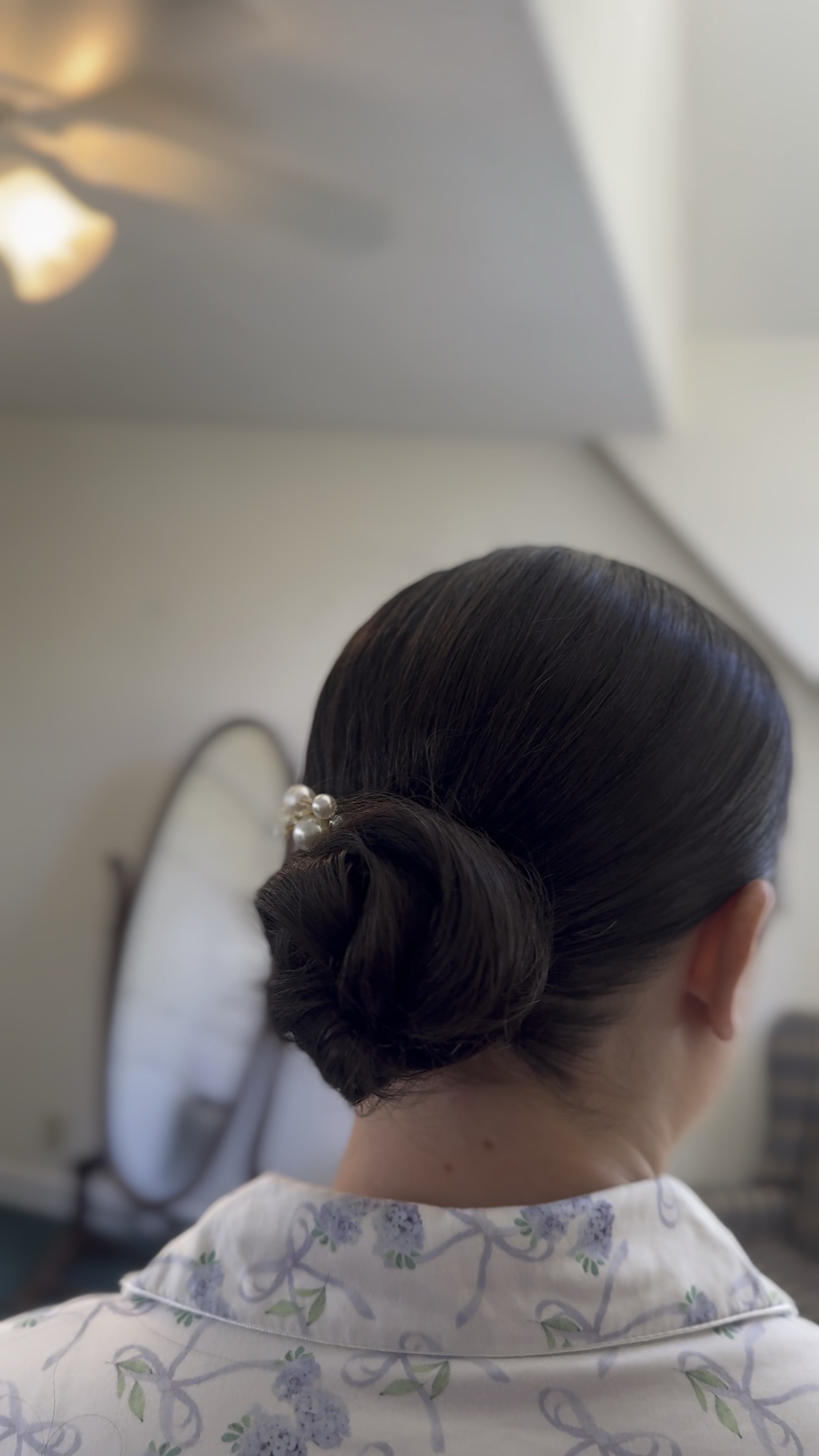 Back view of a bride wearing a polished dark low bun
